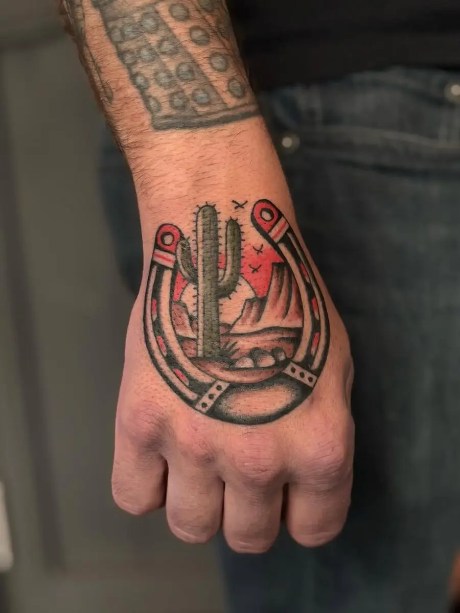 Unique horseshoe tattoo featuring cactus landscape
