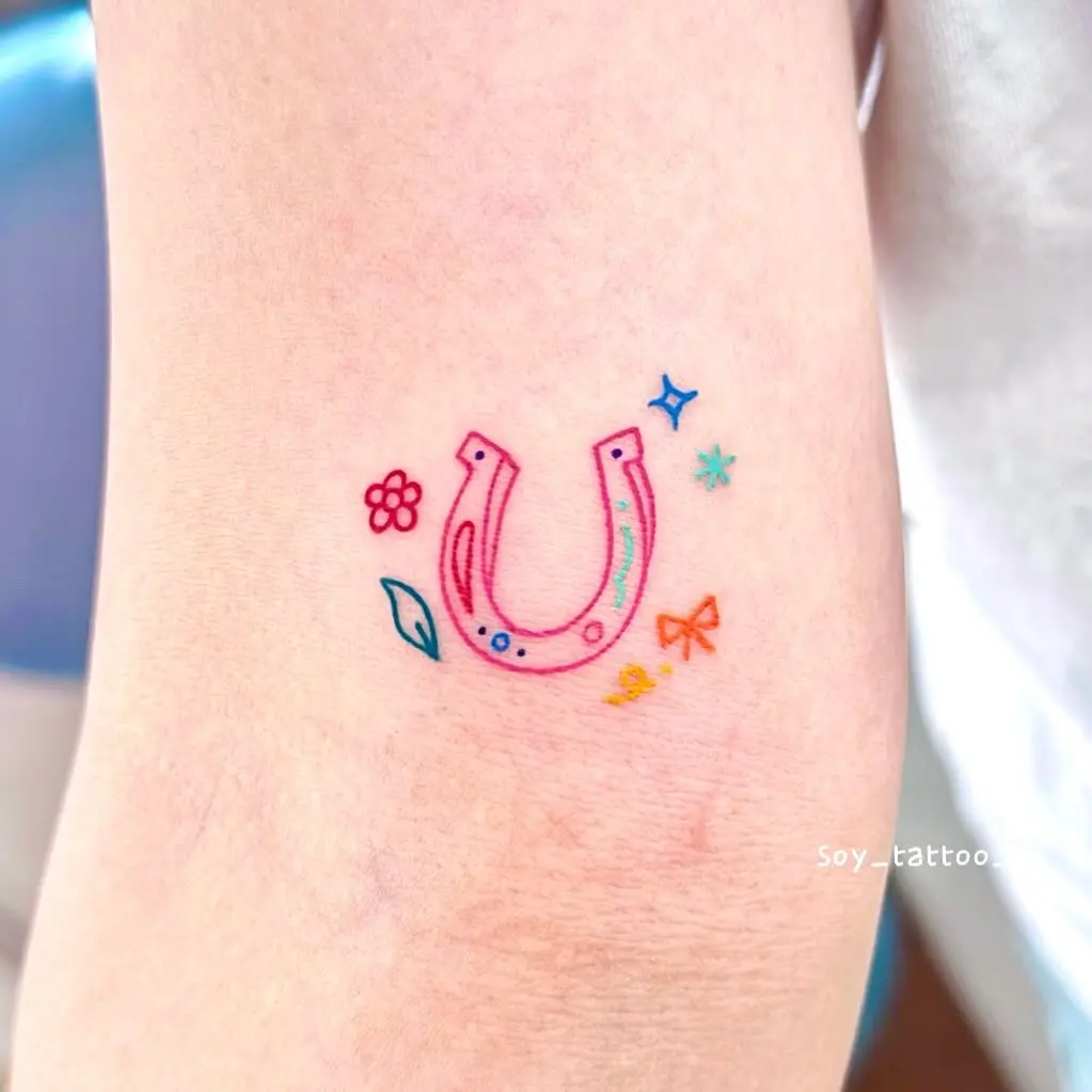 Charming horseshoe tattoo with vibrant decorations