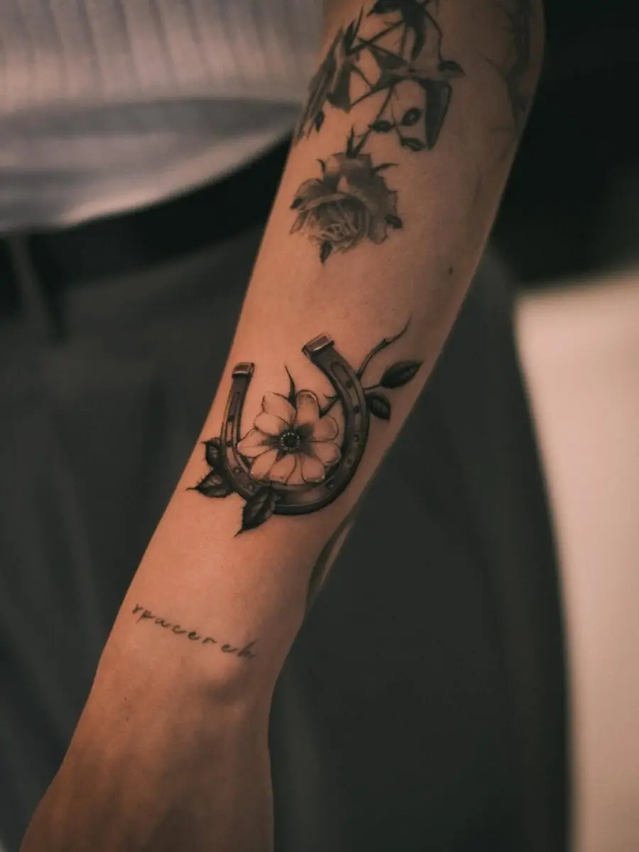 Stylish horseshoe tattoo with floral elements