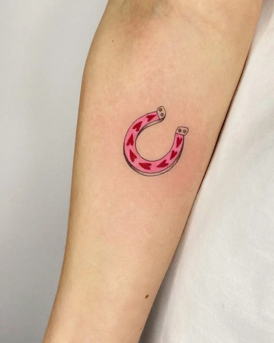 Charming pink horseshoe tattoo with hearts