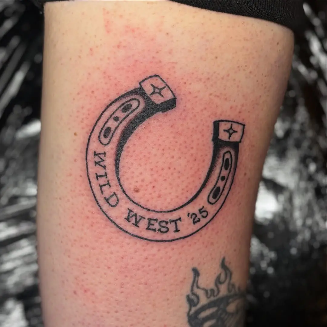 Bold horseshoe tattoo with Wild West flair