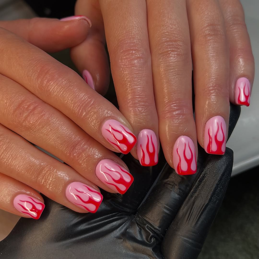 Stylish flames on hot pink nails