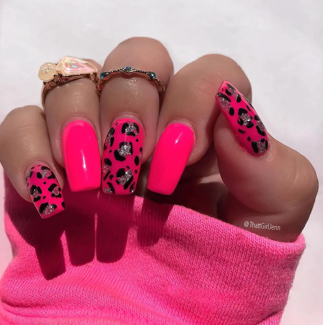 Bold hot pink nails with leopard accents