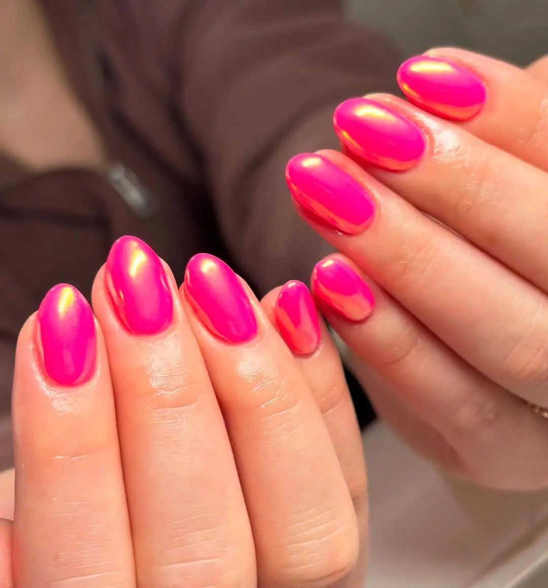 Bold hot pink nails with glossy finish