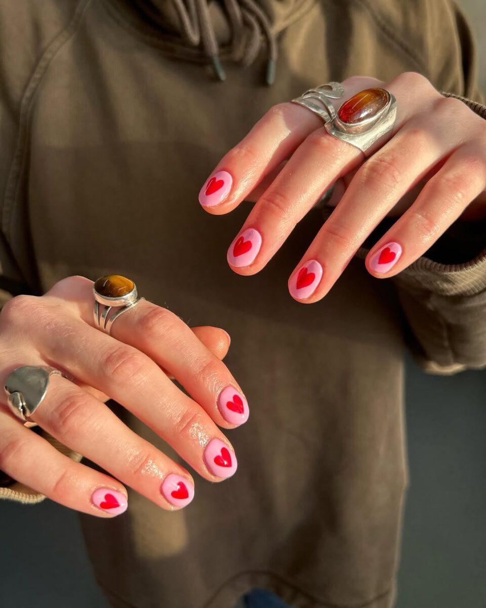 Charming hot pink nails with heart accents