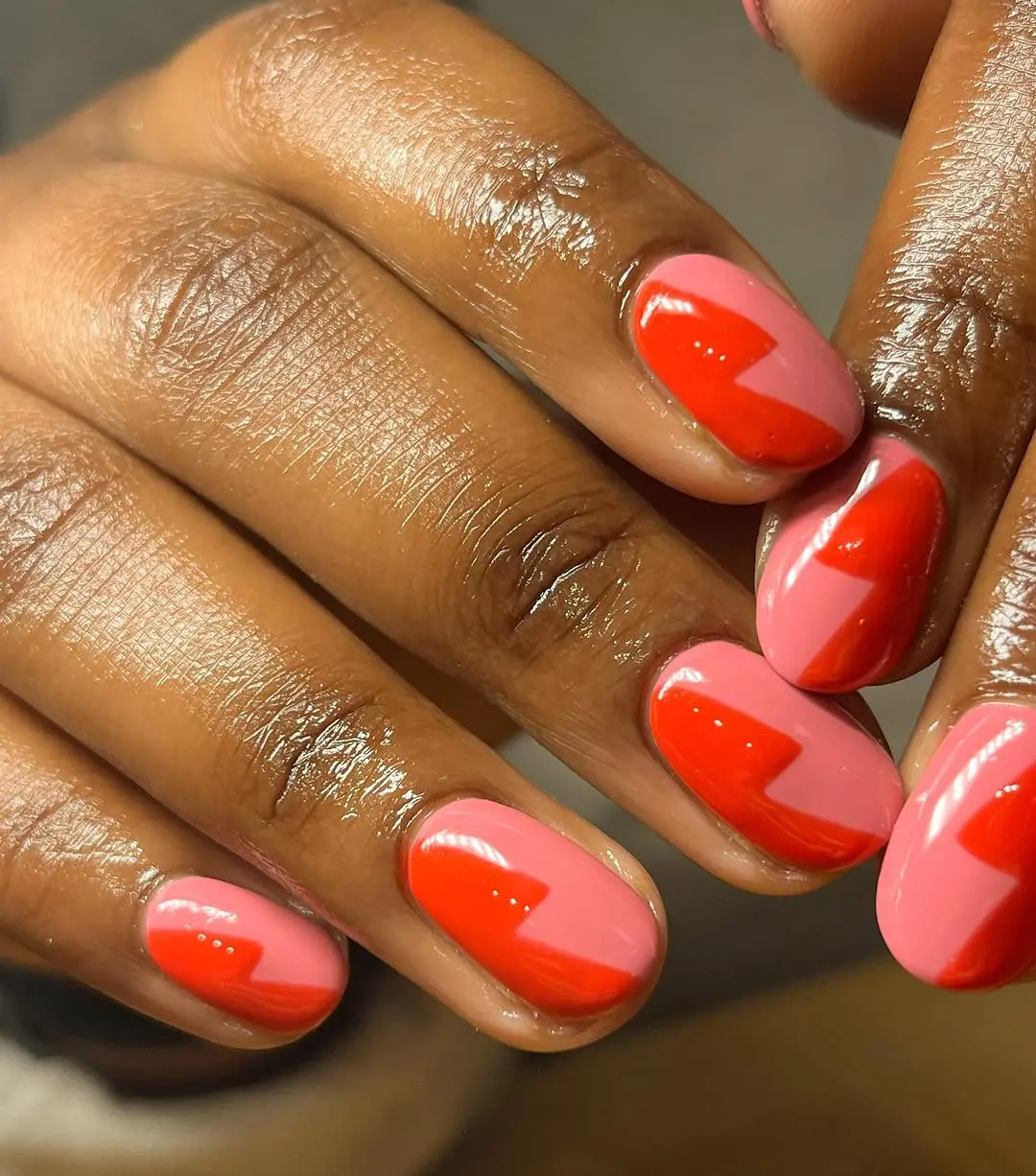Vibrant pink nails with striking red accents