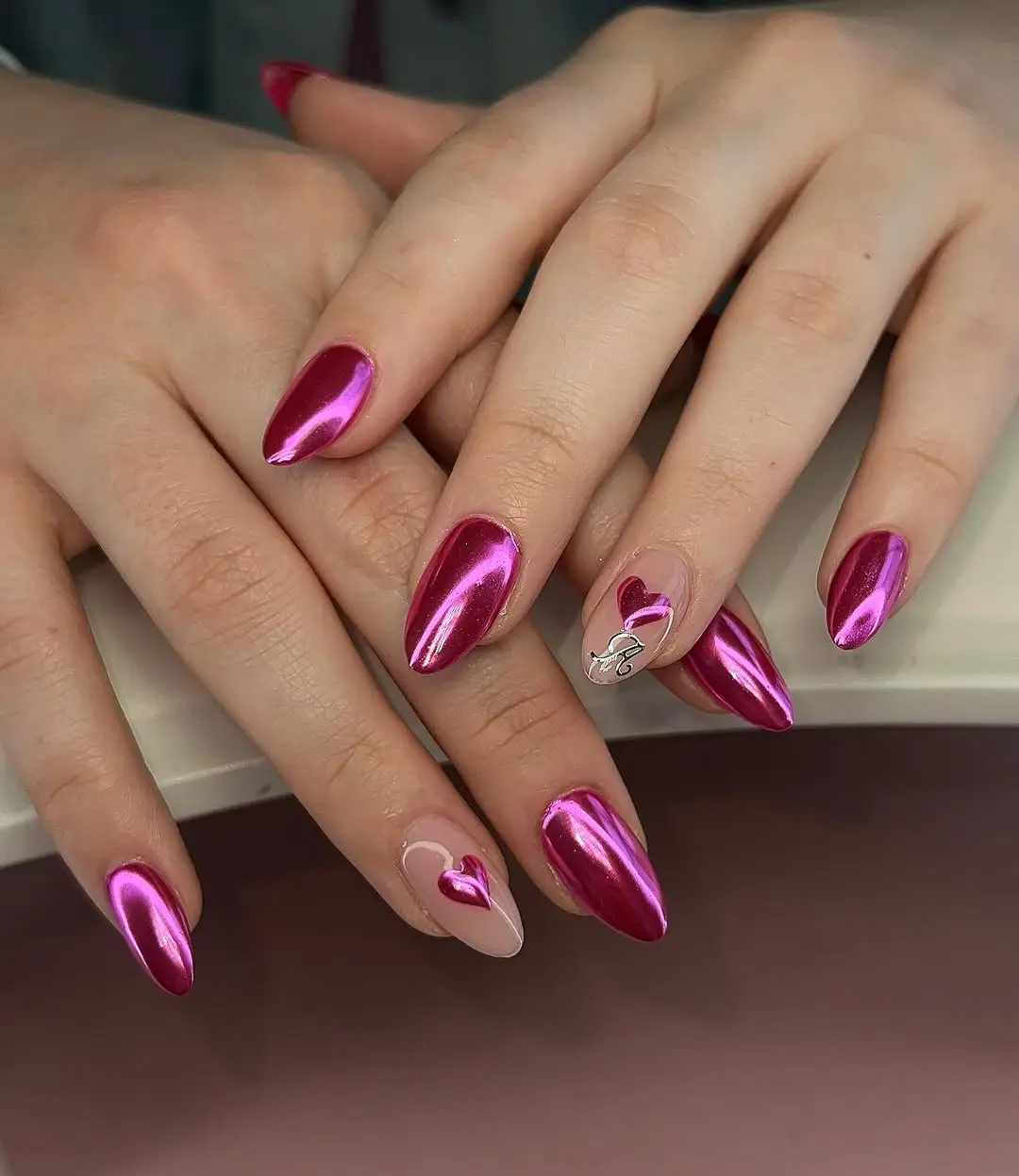 Shiny hot pink nails with heart accents