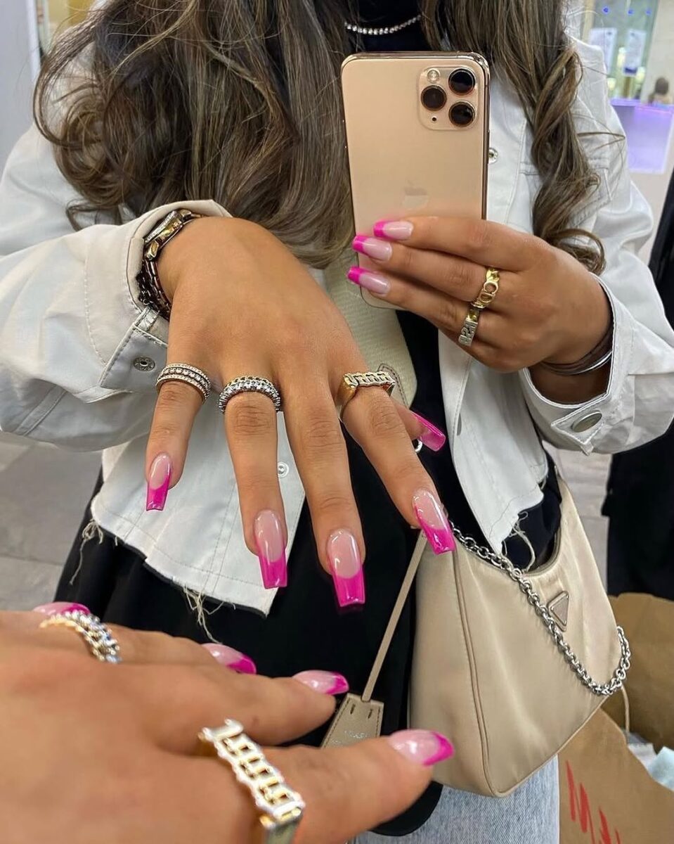 Vibrant hot pink gel nails with elegant tips