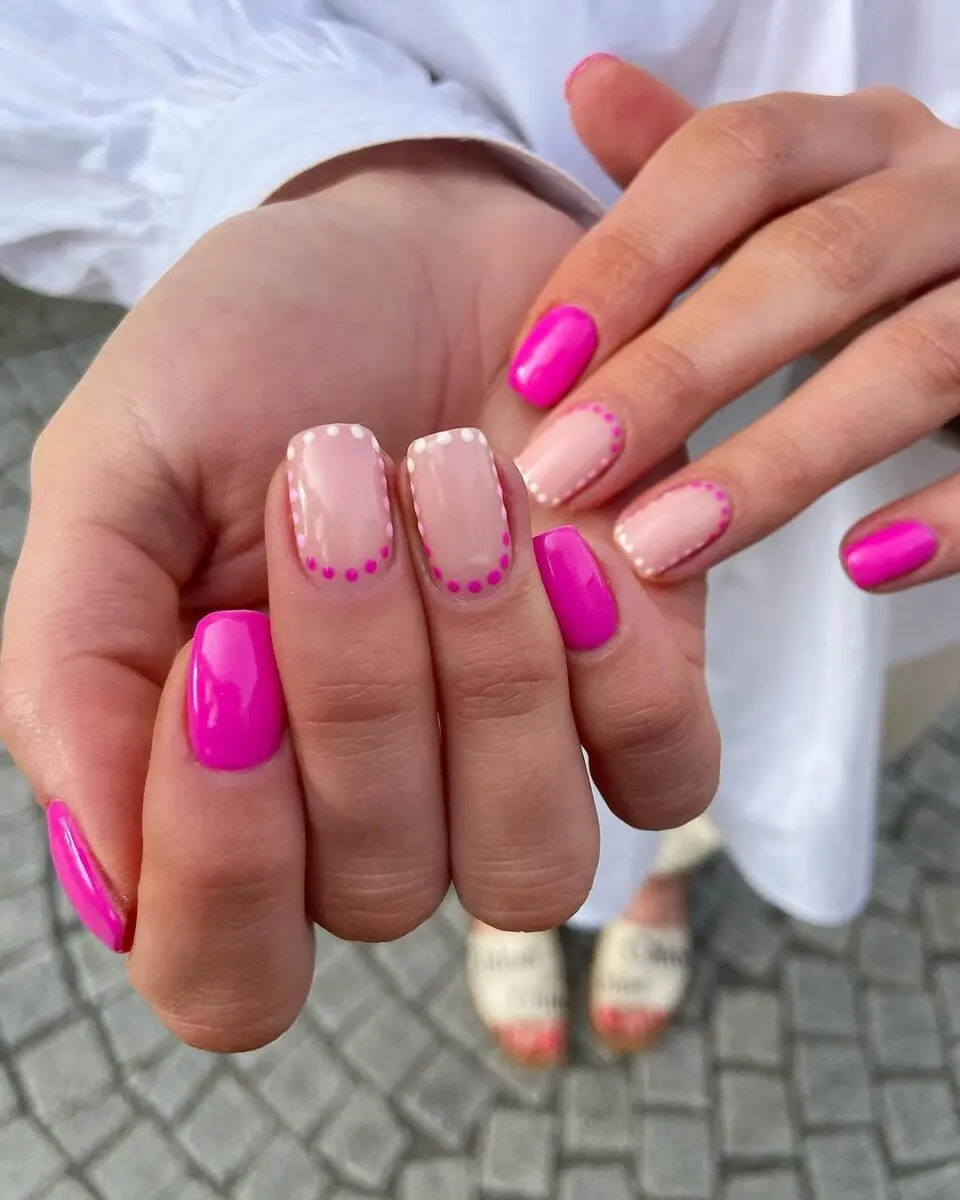 Vibrant hot pink nails with chic accents