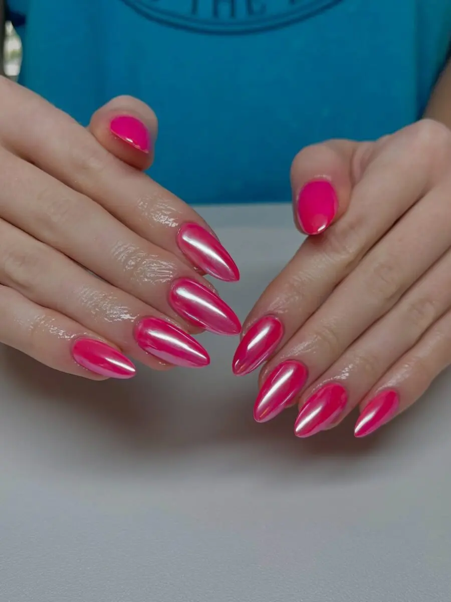 Vibrant hot pink stiletto nails with shine