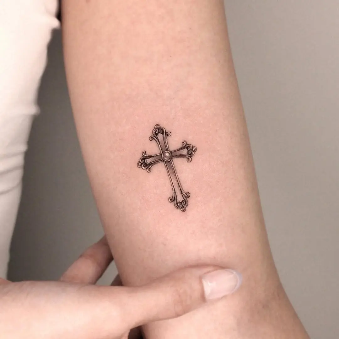 Elegant and intricate cross tattoo design