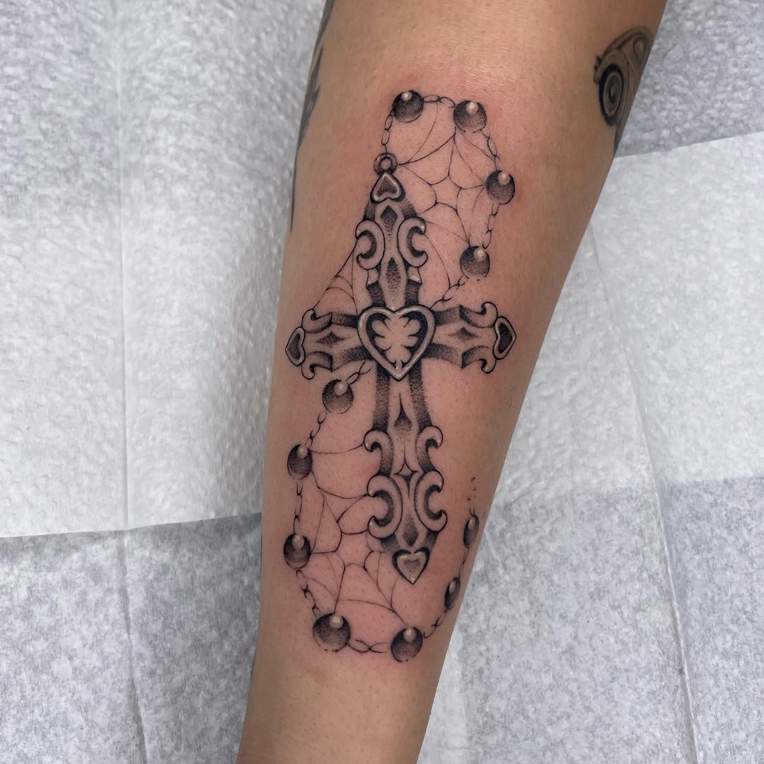 Intricate cross tattoo with web and ball details