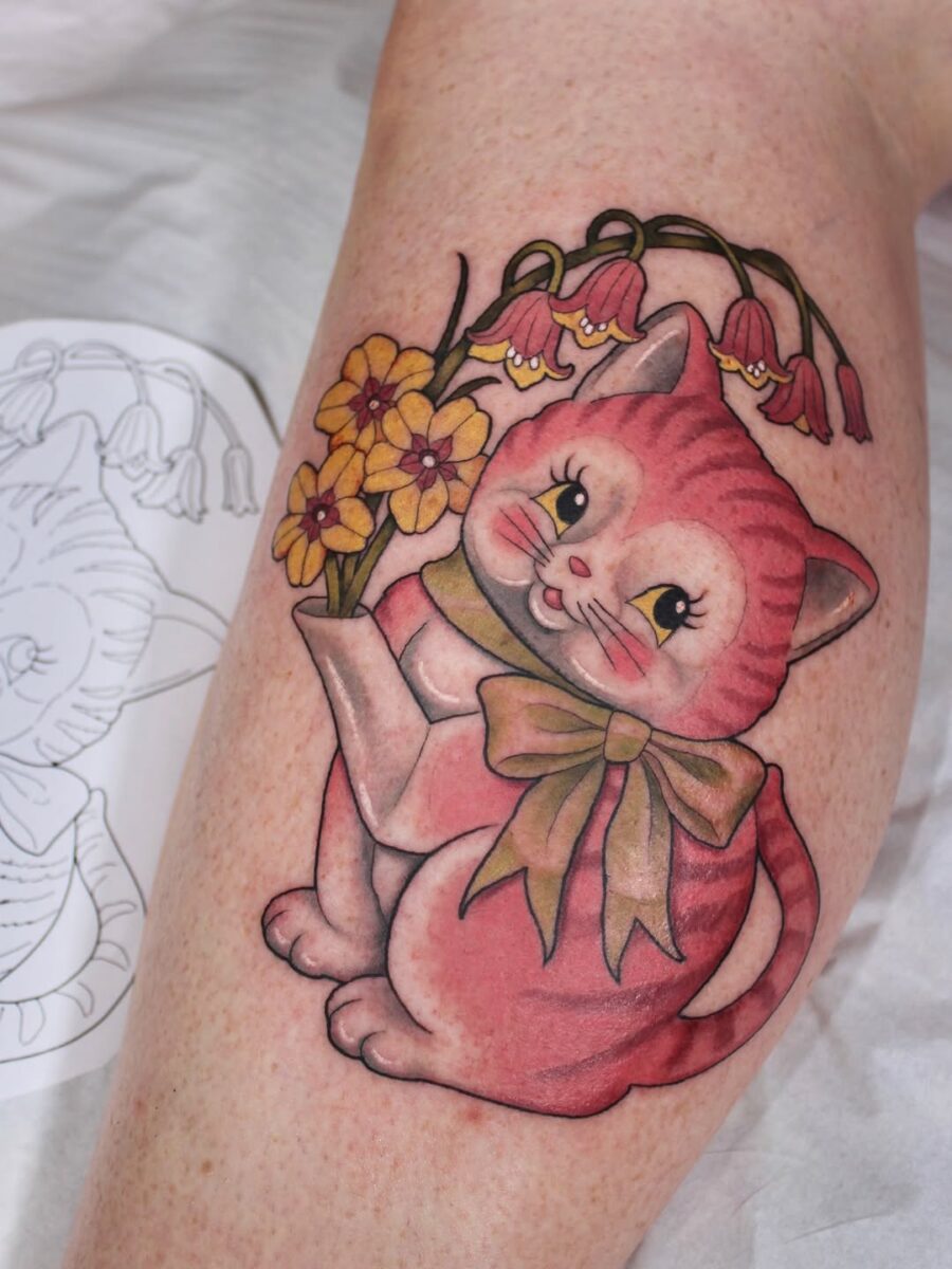 Adorable cat tattoo with cheerful flowers