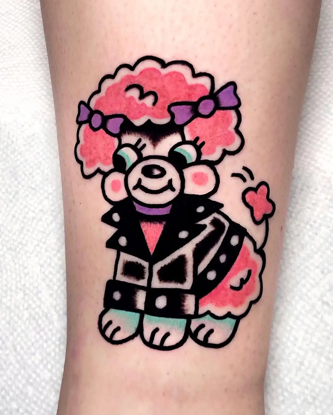 Adorable poodle tattoo with punk vibes