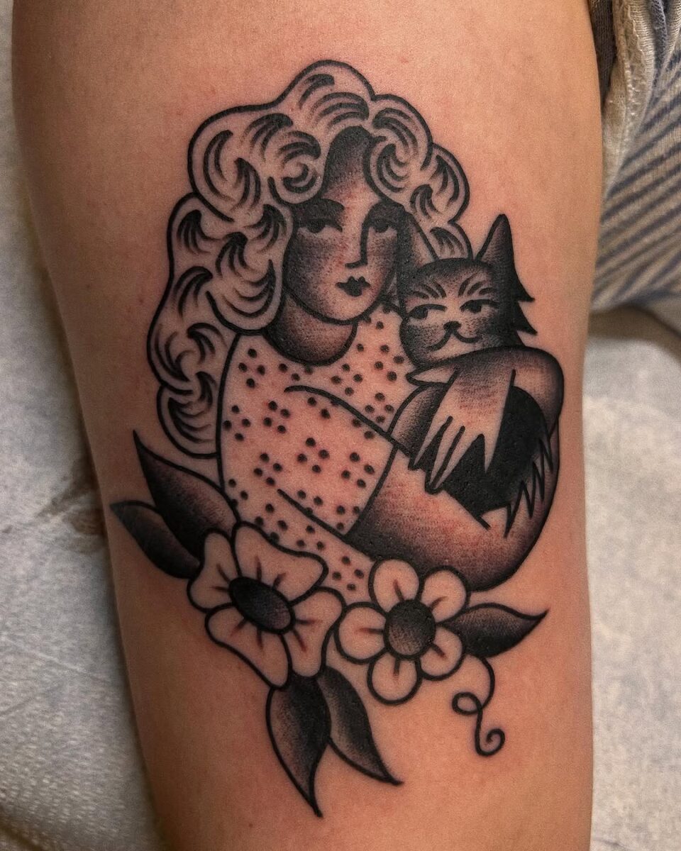 Charming woman with her feline companion tattoo