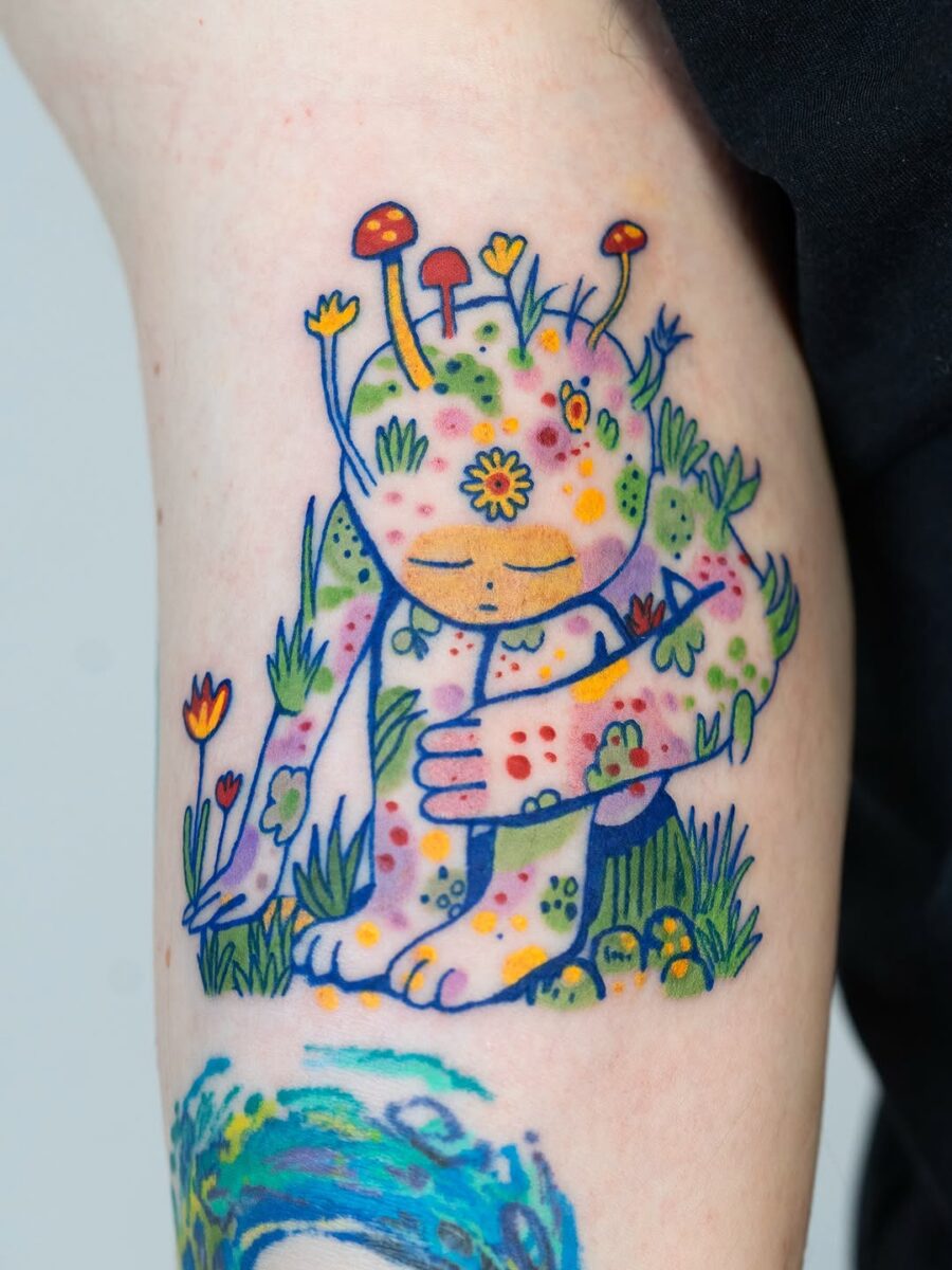 Whimsical nature-inspired tattoo with vibrant colors