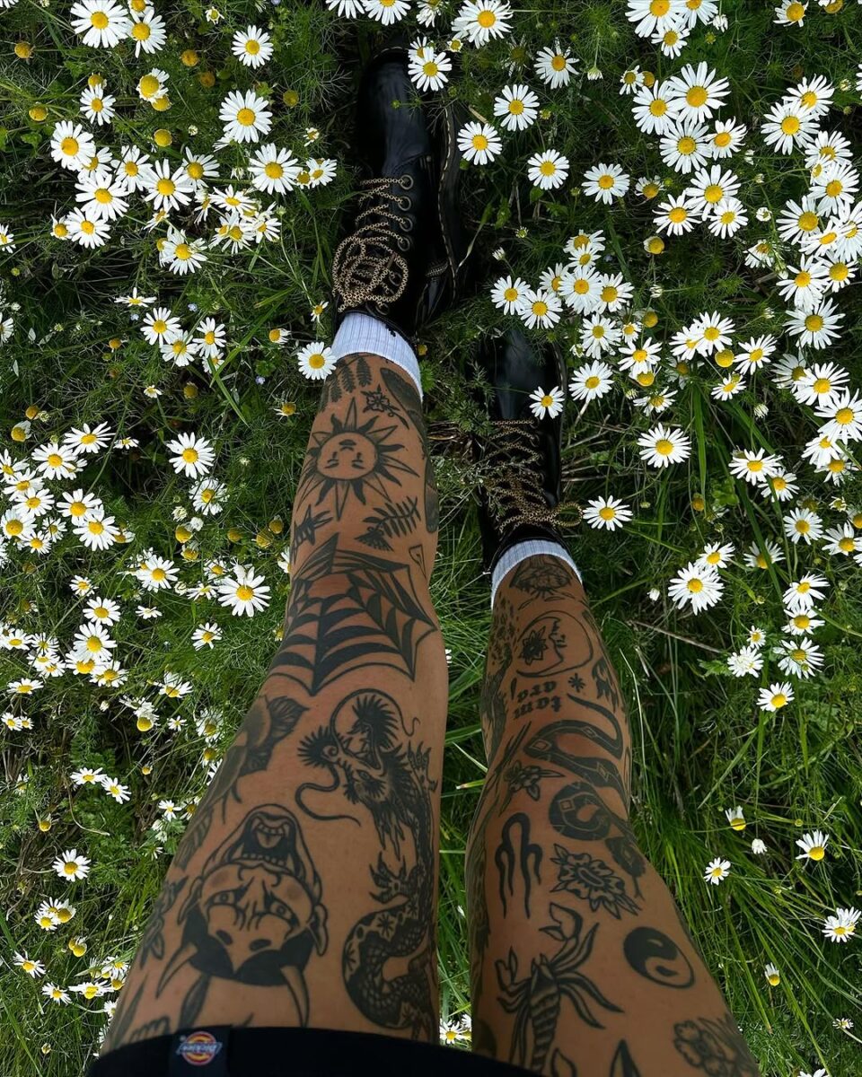 Kitschy Tattoos Amid a Flowering Meadow