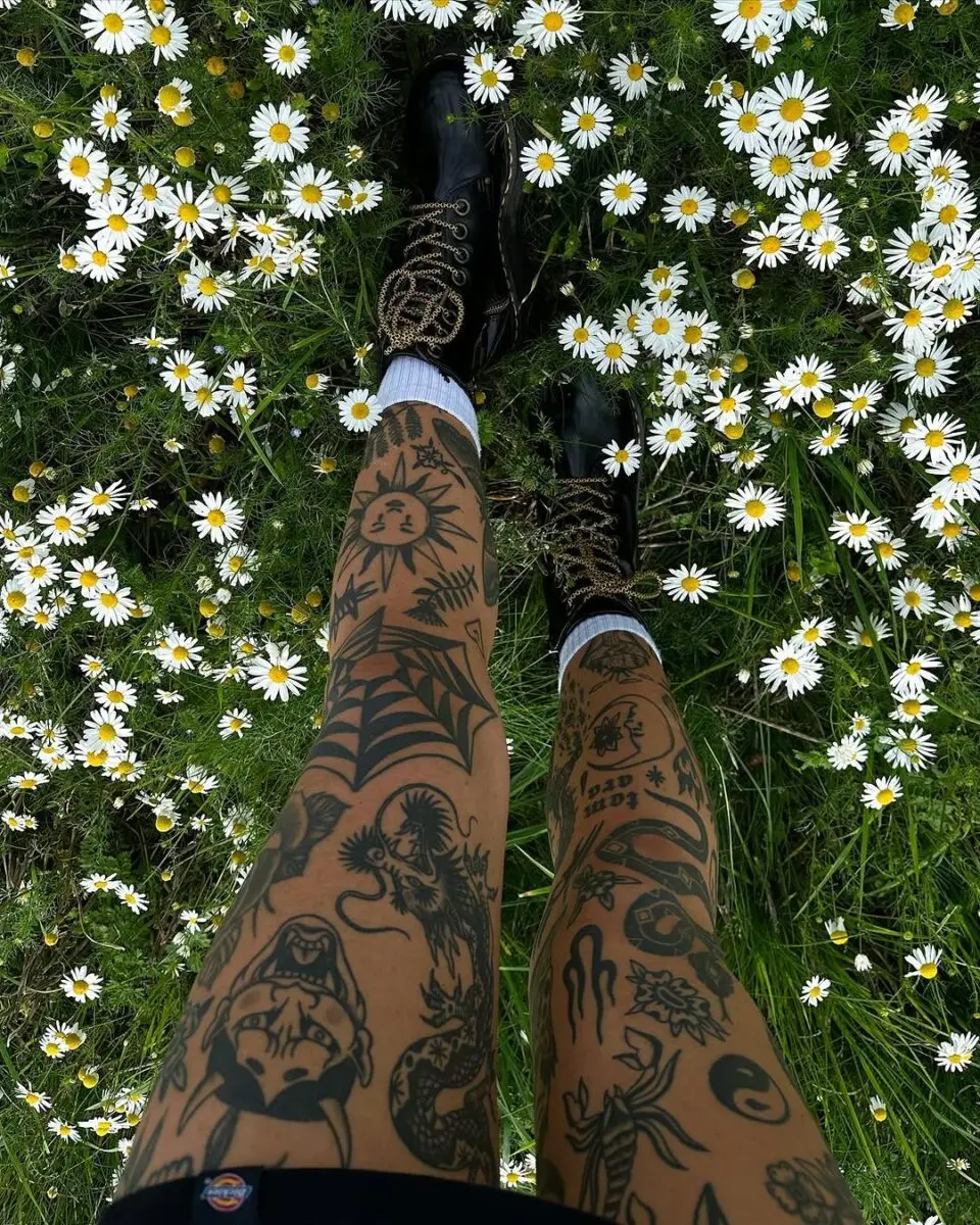 Kitschy Tattoos Amid a Flowering Meadow