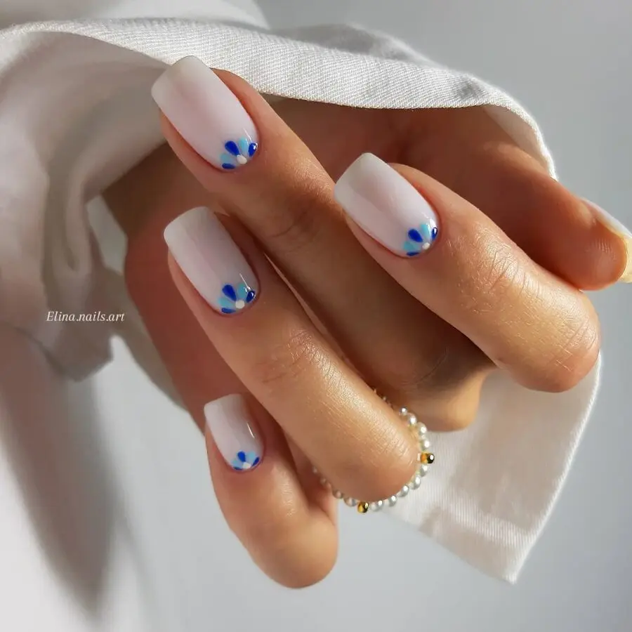 Elegant milky nails with playful blue accents