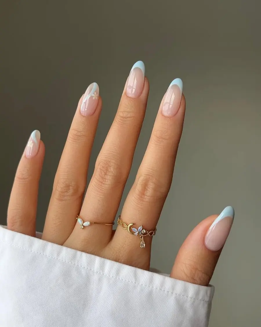 Elegant milky nails with blue tips and flowers