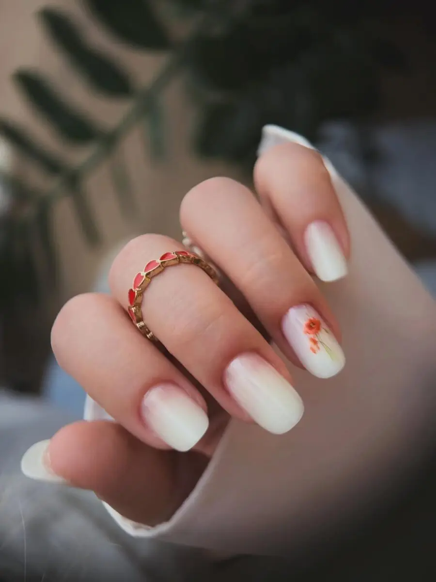 Elegant milky nails with floral accents and soft tones