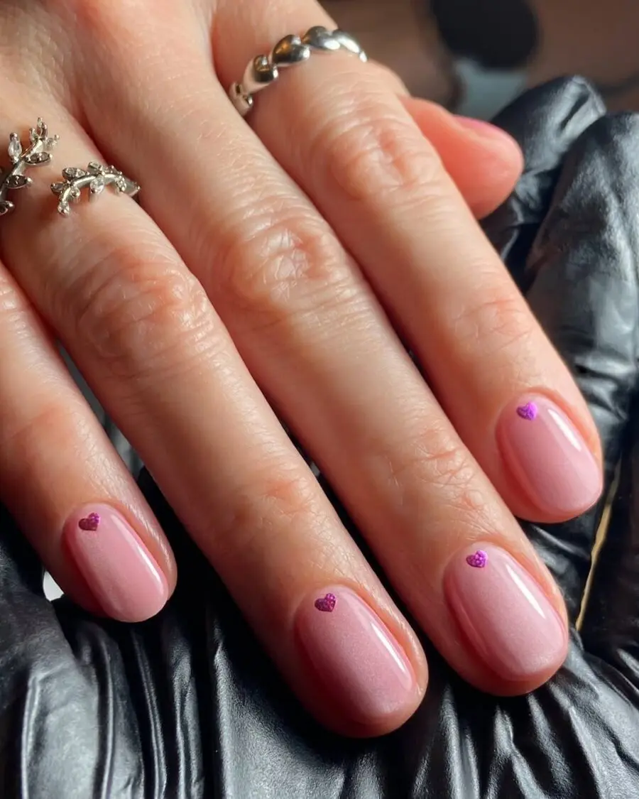 Charming milky nails with playful heart accents