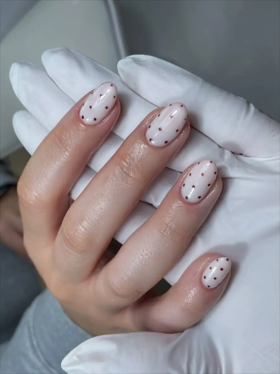Elegant milky nails with playful dot accents