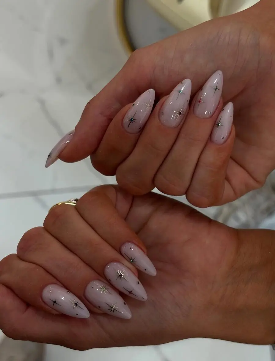Elegant milky nails adorned with star accents