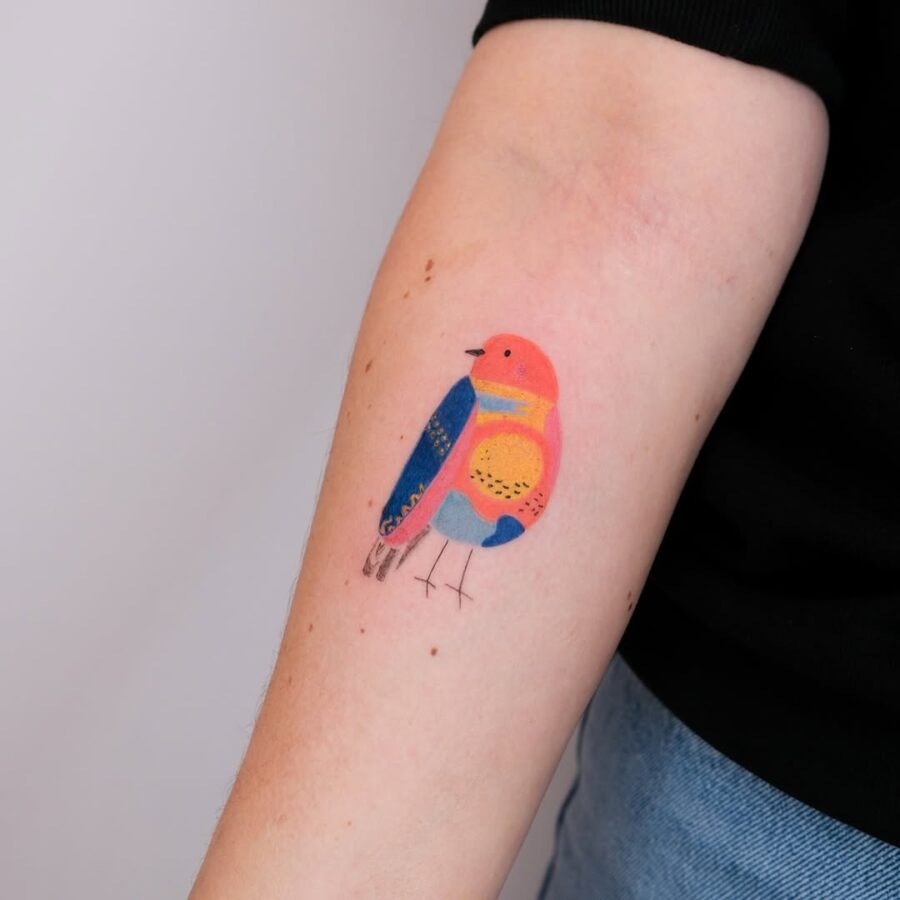Vibrant bird tattoo promoting mindfulness and peace