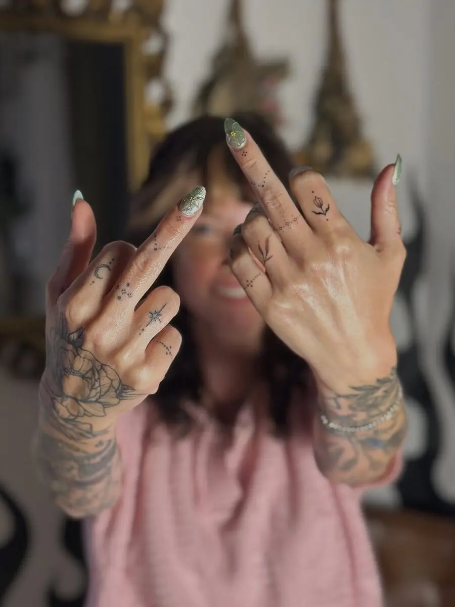 Expressive hands adorned with mindful tattoos.