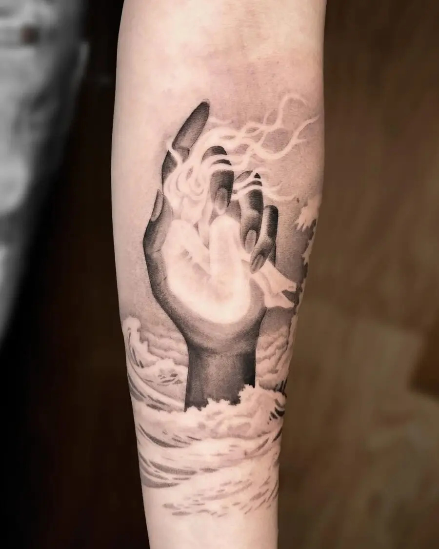Serene hand emerging from waves and clouds