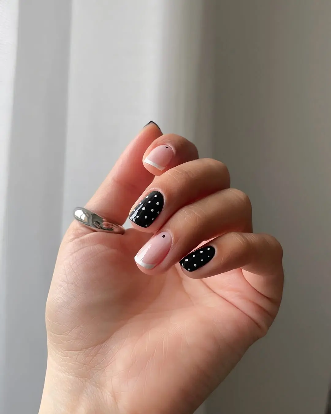 Sleek Black and White Polka Dot Nail Design