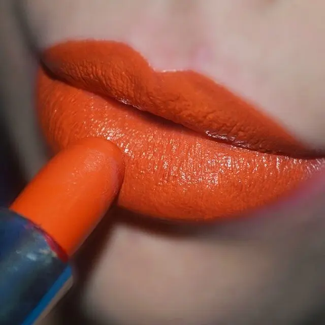 Bold orange lipstick for a vibrant summer look