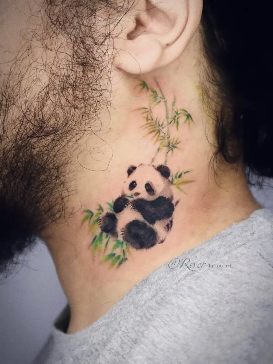 Charming panda tattoo nestled in bamboo