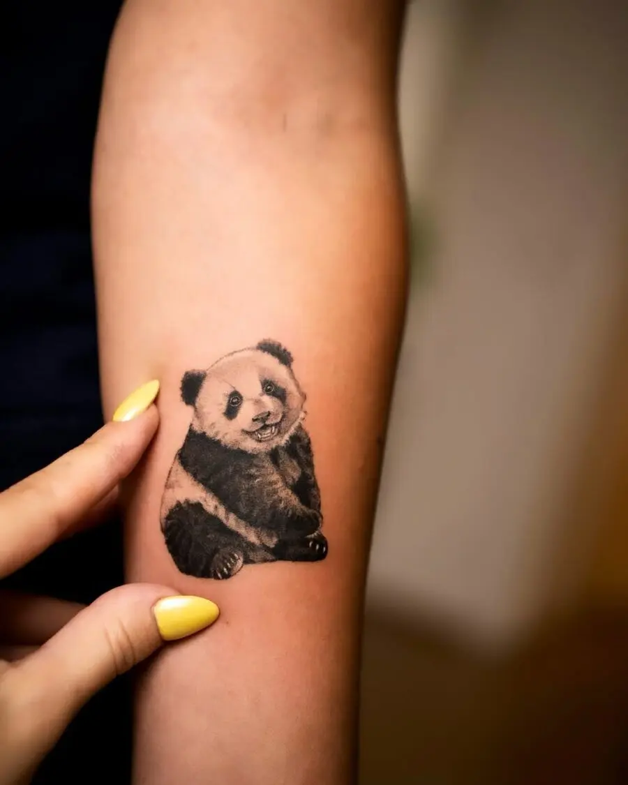 Adorable panda tattoo on forearm