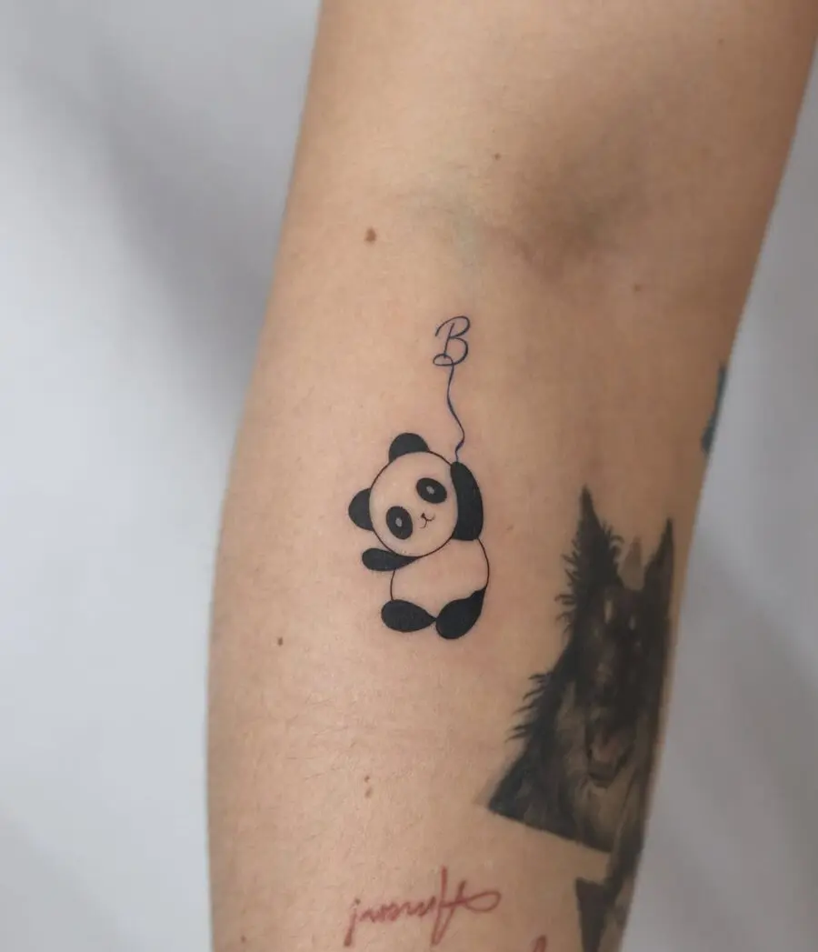Adorable panda tattoo with a playful twist