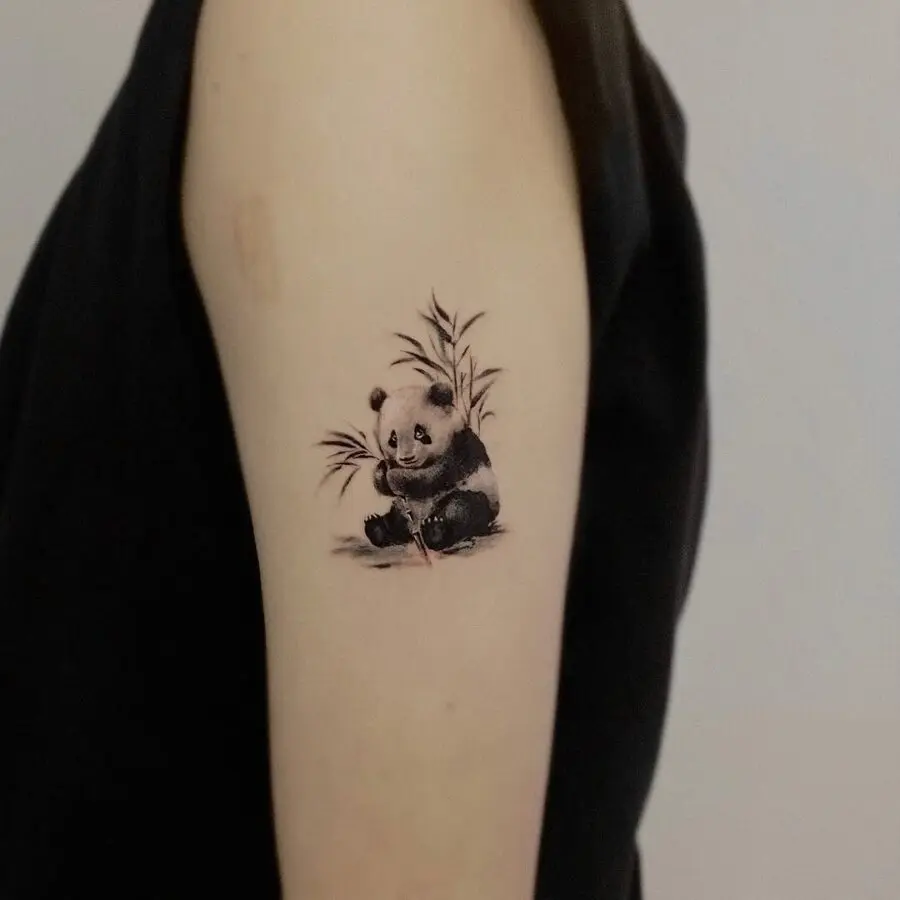 Adorable panda tattoo with bamboo accents