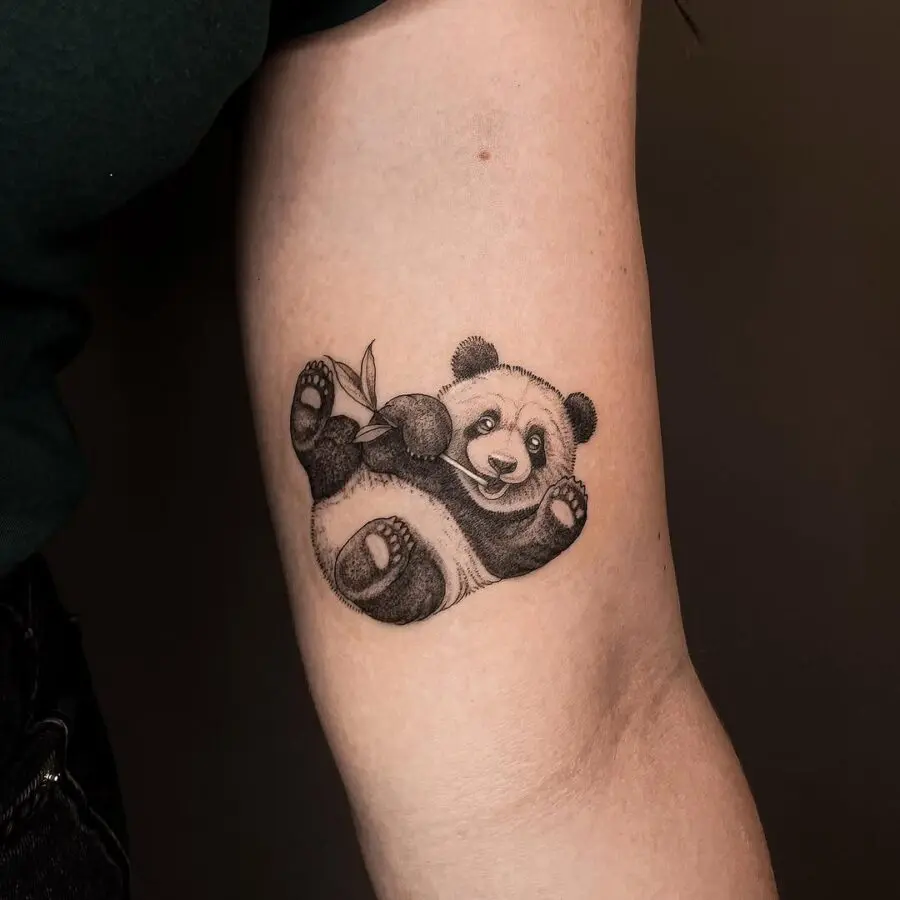 Adorable panda tattoo with bamboo detail