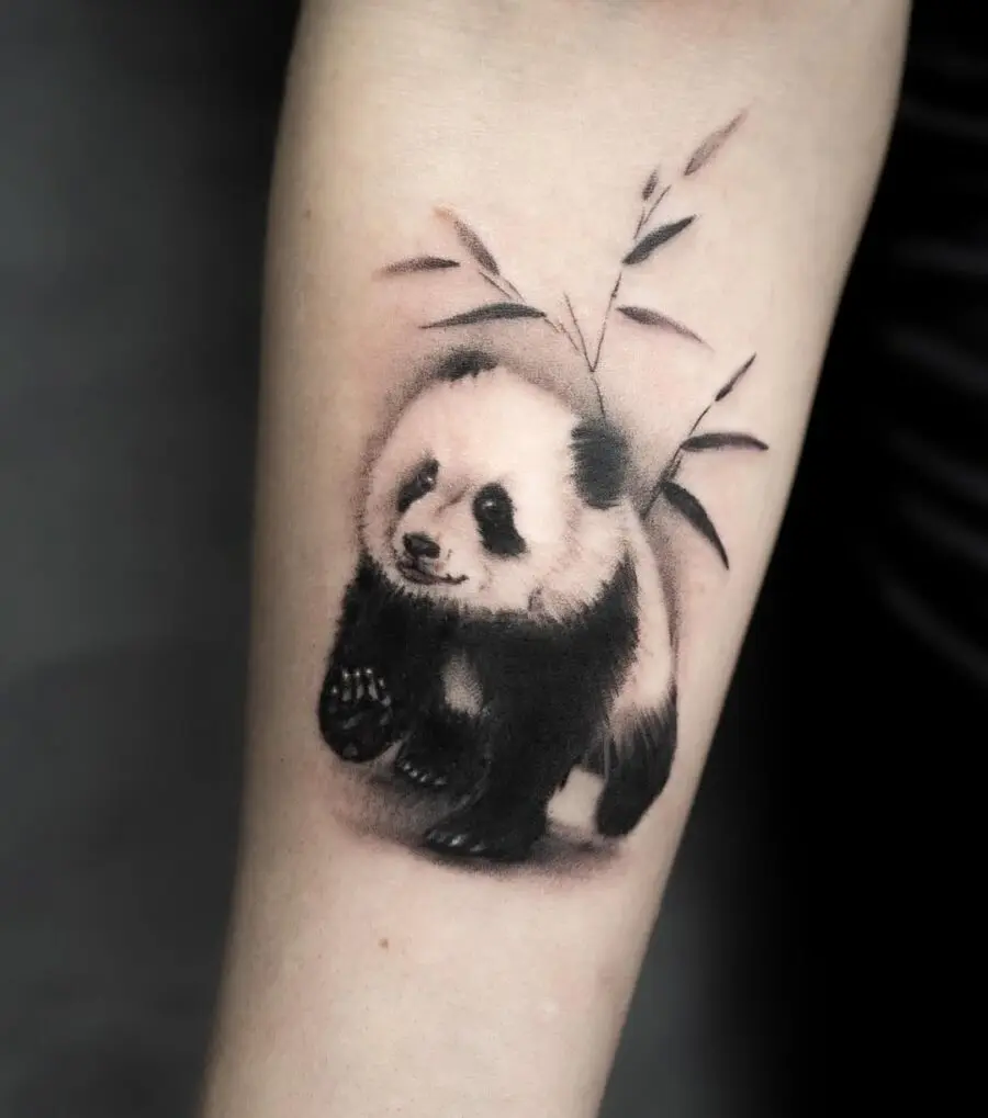 Charming panda tattoo with bamboo accent