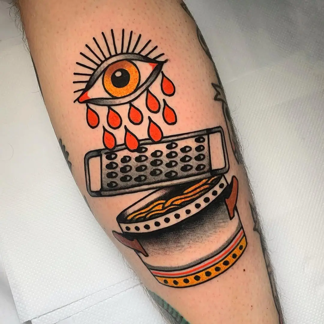 Unique pasta tattoo blending eyes and graters