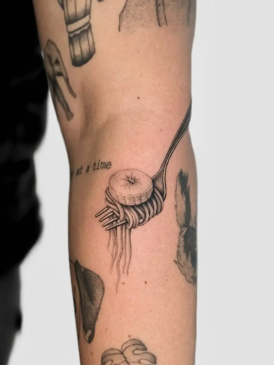 A whimsical fork with spaghetti tattoo design