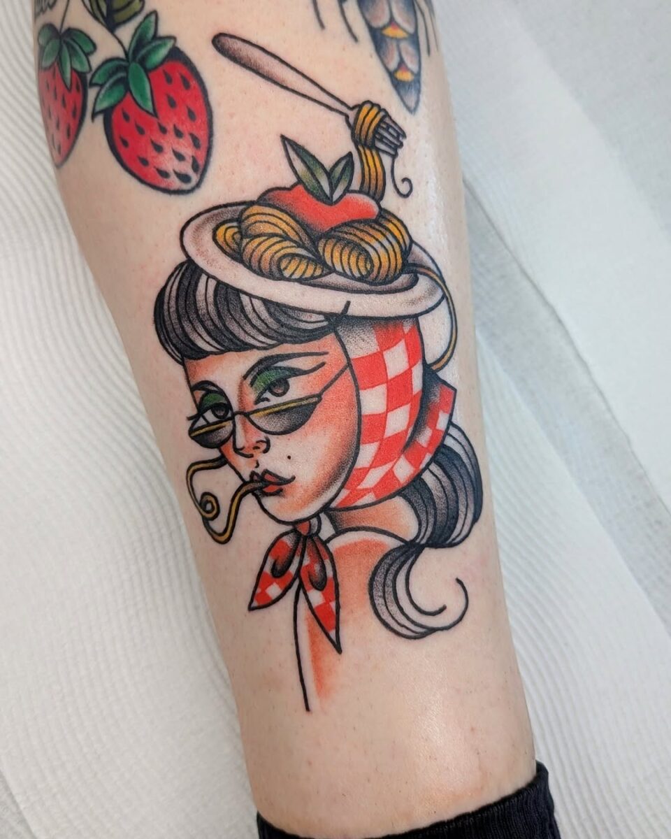 Whimsical pasta-themed tattoo art on a woman