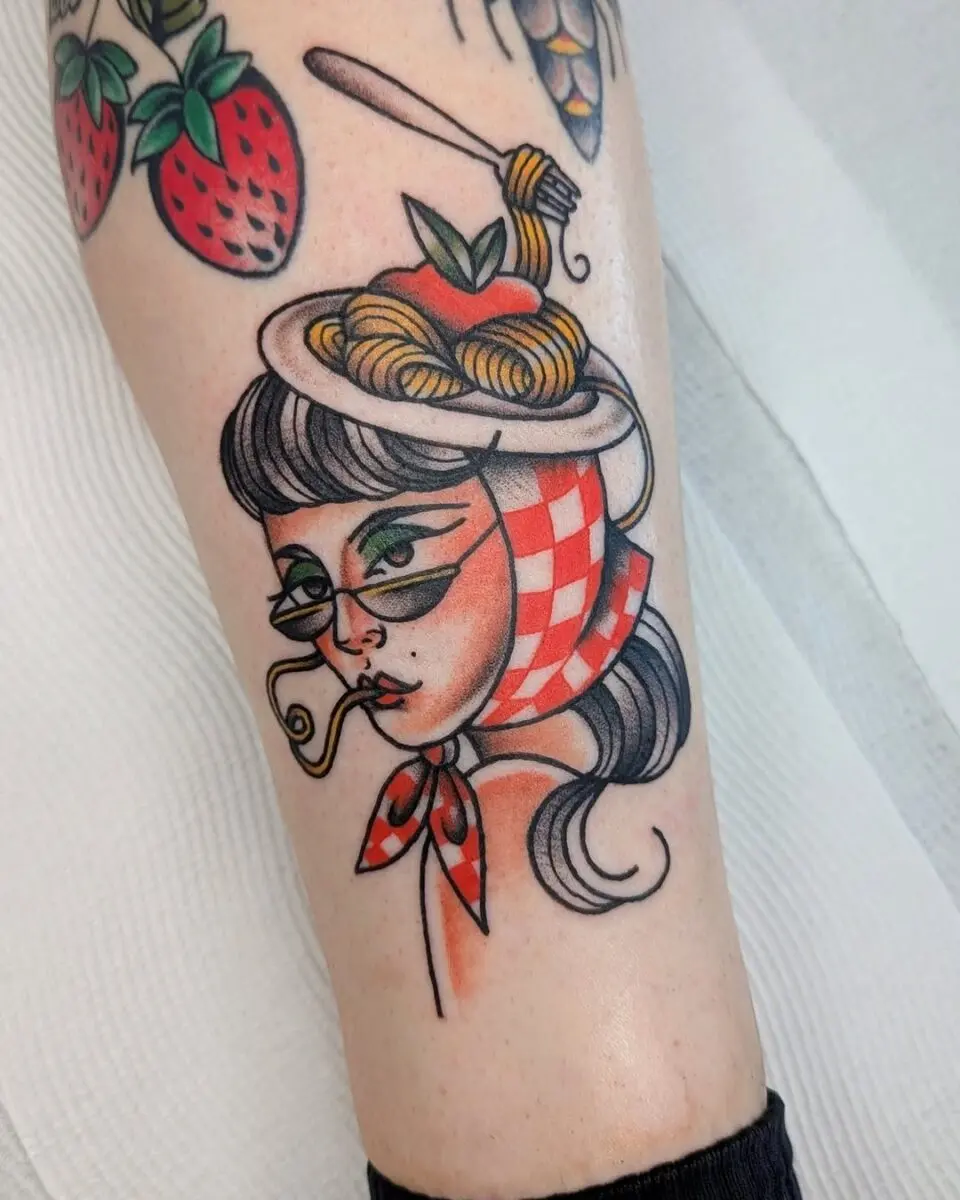 Whimsical pasta-themed tattoo art on a woman