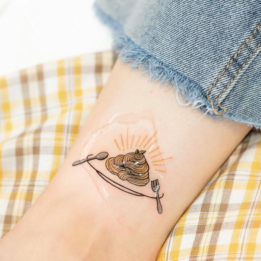 Charming spaghetti tattoo with playful cutlery design