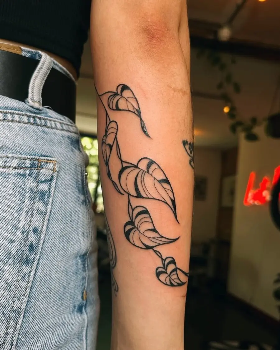 Elegant floral peace tattoo design on arm
