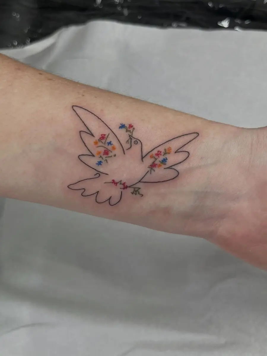 Colorful dove tattoo symbolizing peace and harmony