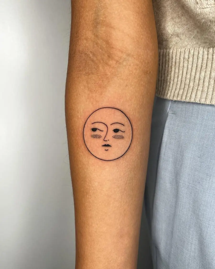 Minimalist sun face tattoo radiating calm vibes