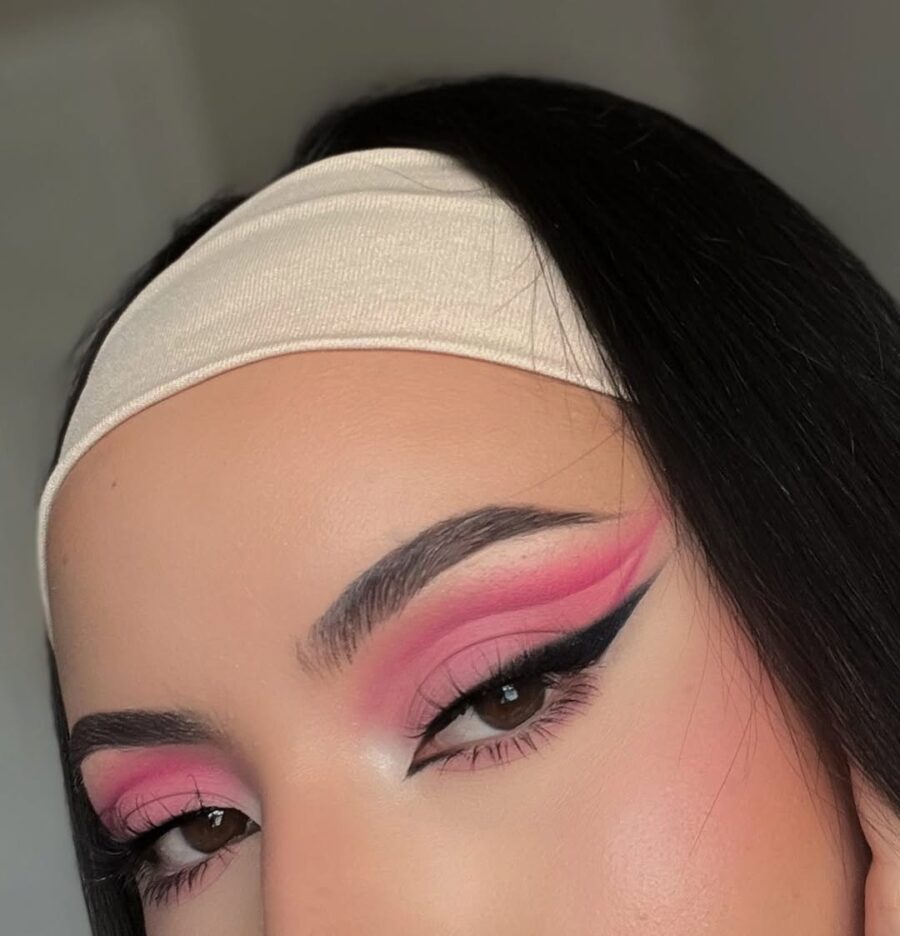 Bold pink eyeshadow with graphic liner design
