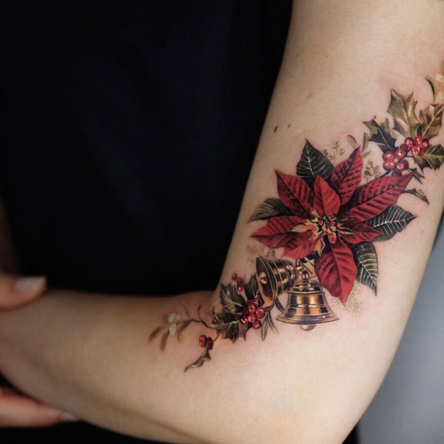 Vibrant poinsettia tattoo with bell detail