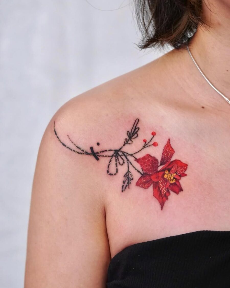 Vivid poinsettia tattoo accentuates shoulder elegance